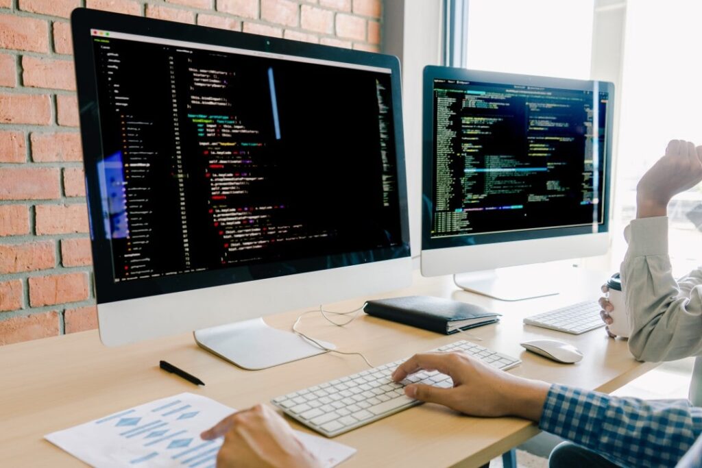 Young developers coding together in a collaborative workspace

